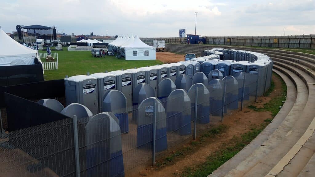 Row of portable toilets at an outdoor event in Gauteng.